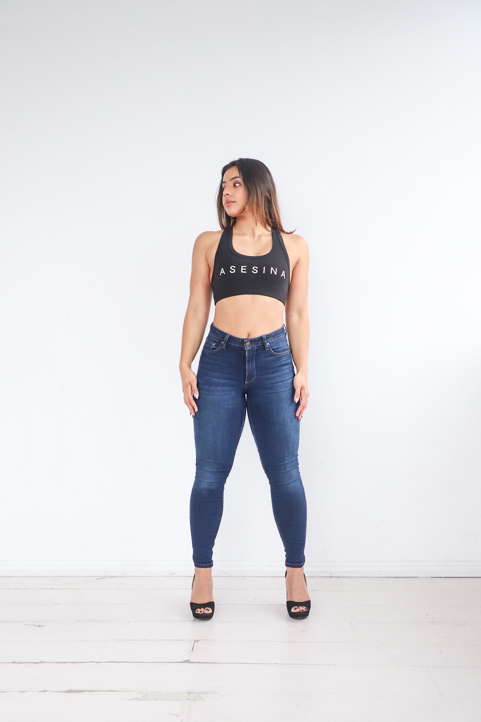 Alicia wearing the Power Jeans posing to the front. The Power Jeans are made for the athletic body fitting your hips, thighs, and waist. Alicia is 5'3 with a 29 inch waist, 38 inch hips, and is wearing a size 27.